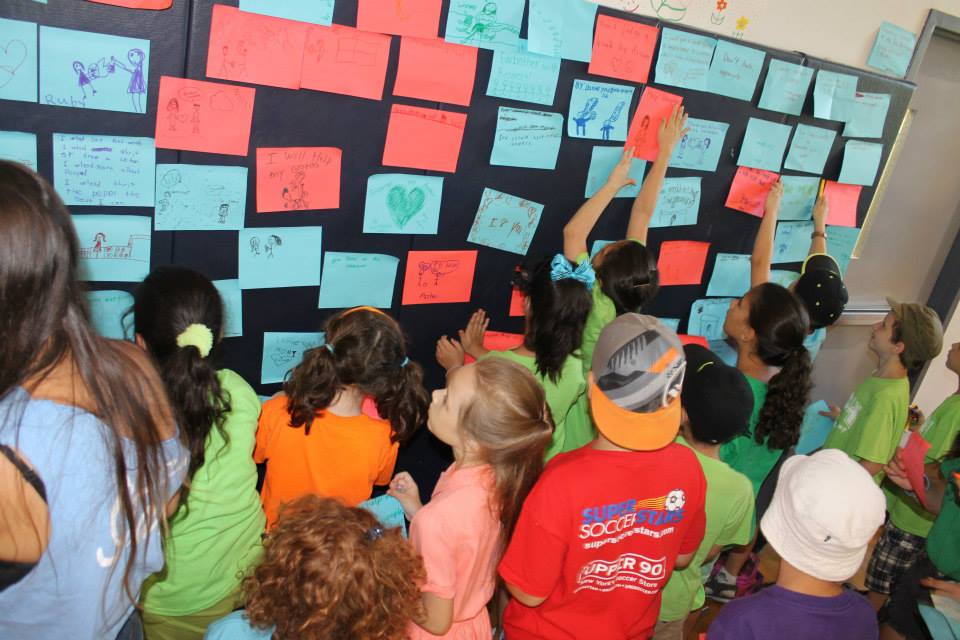 Campers write and post their ideas about spreading loving kindness throughout camp.